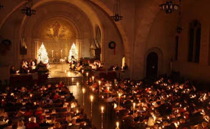 Masses lighting candles on Christmas Eve.
