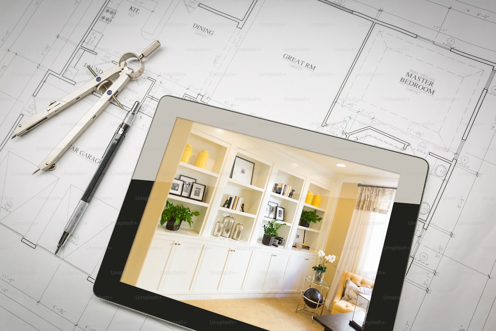 A tablet on top of a custom home blueprint