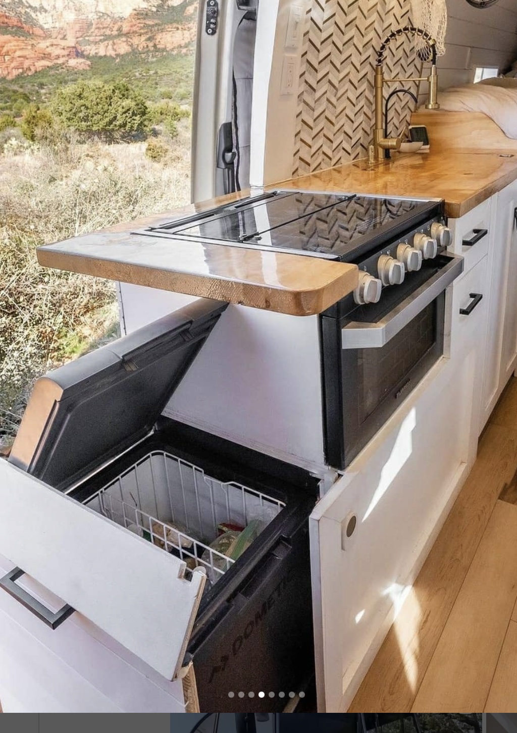 Stylish kitchen in a van with storage, sink and stove. 