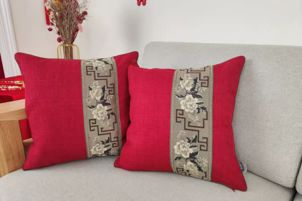 Red square sofa cushion with grey floral and Chinese symbol pattern, in velvet cotton and chenille.
