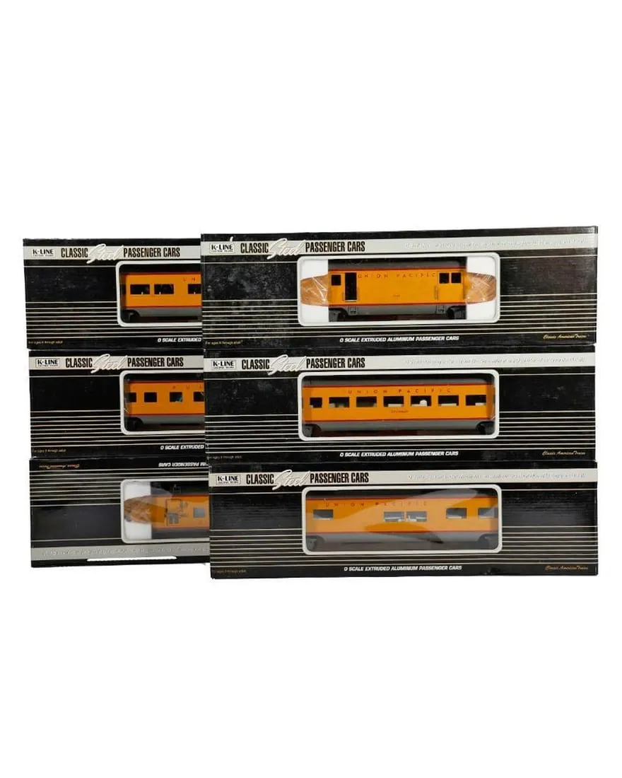 A group of yellow train cars in packaging

Description automatically generated