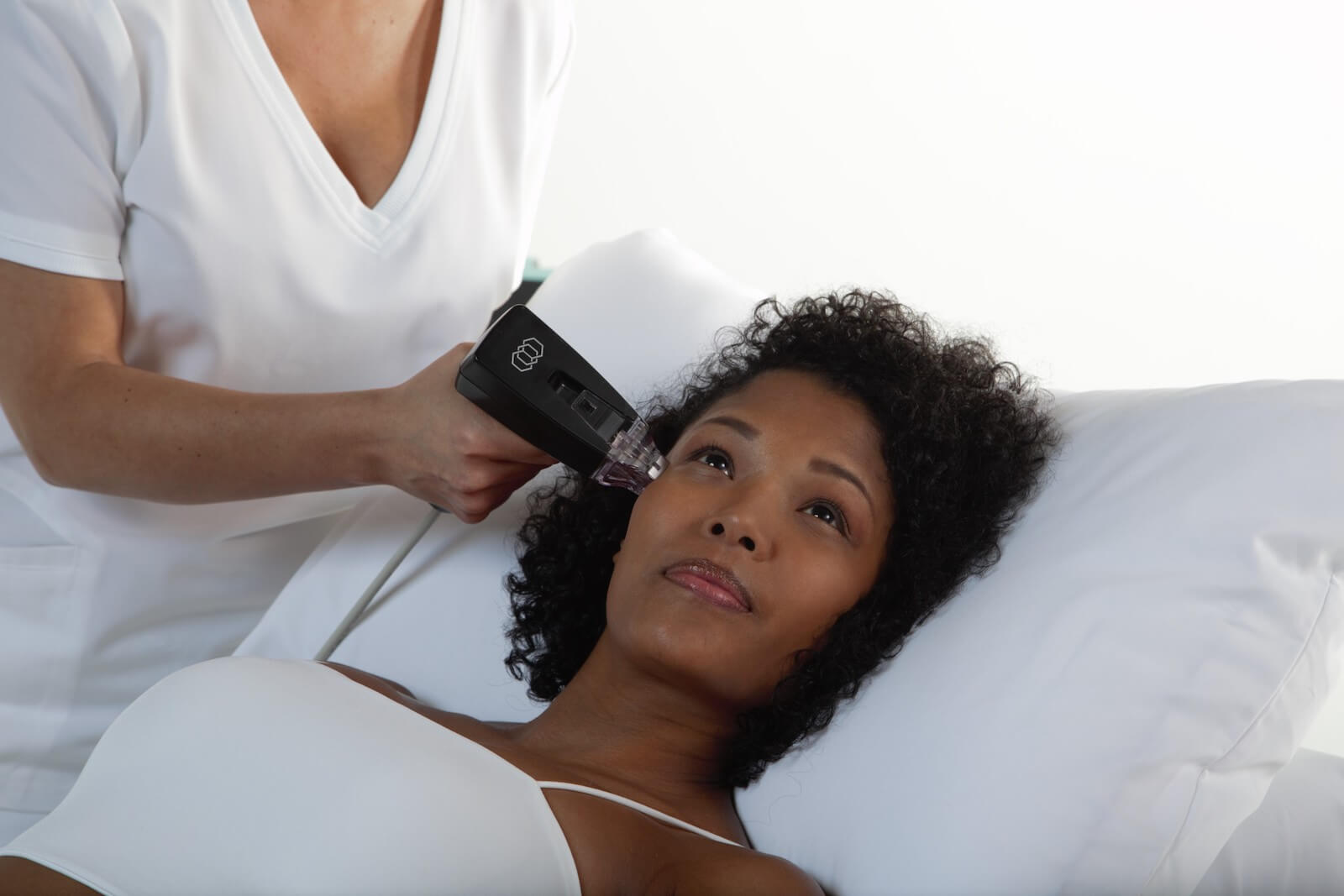A woman at an aesthetics clinic being treated with Morpheus8. 