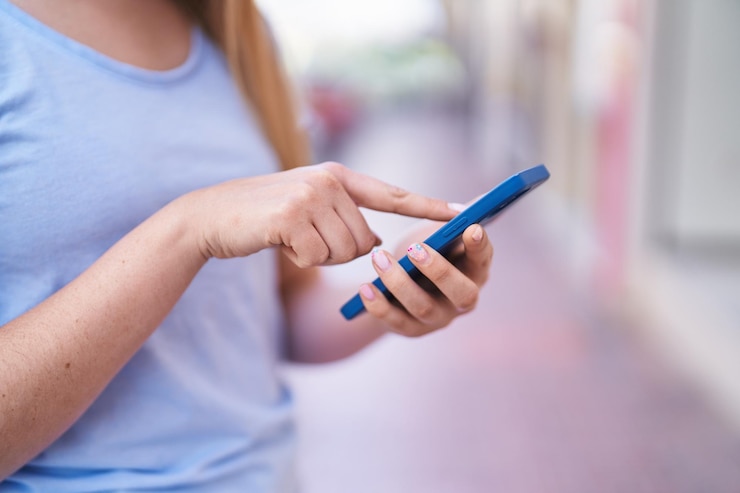 woman sending SMS via phone