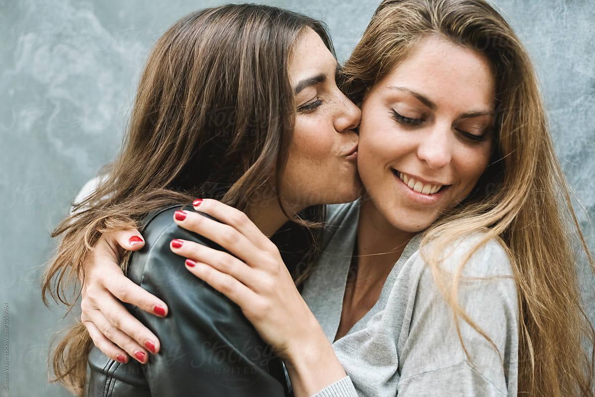 Best Girl Friends Kissing And Hugging Each Other" by Stocksy Contributor  "Simone Wave" - Stocksy