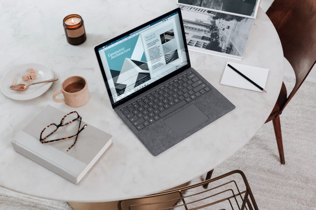 black laptop computer on round table on a Surface Laptop