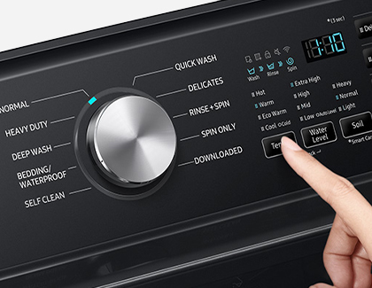 A finger adjusting the settings of a Samsung washer