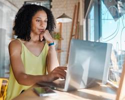 Image of young entrepreneur working on a laptop in a coffee shop