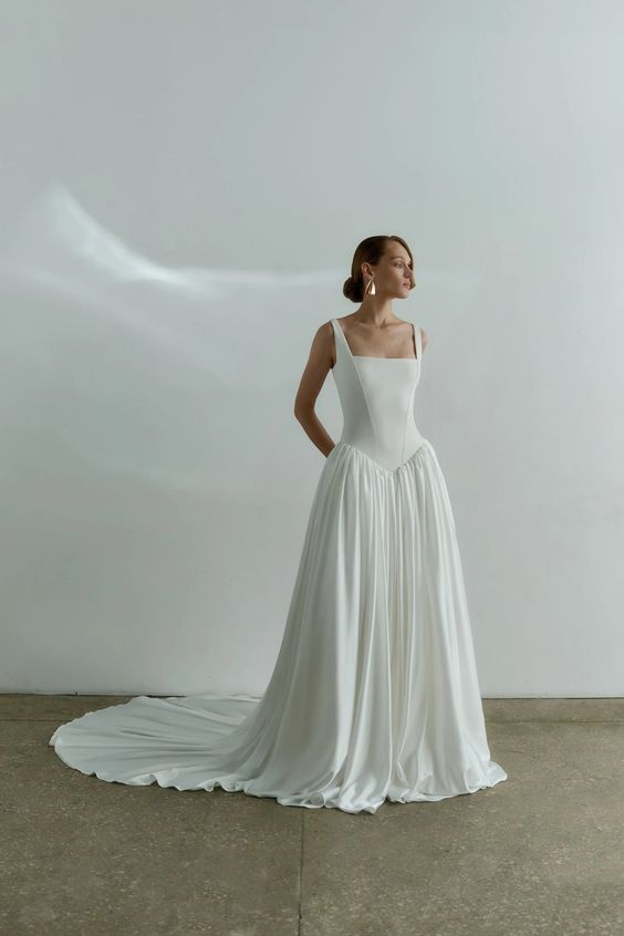 Gorgeous photo showing a lady rocking a white drop waist dress