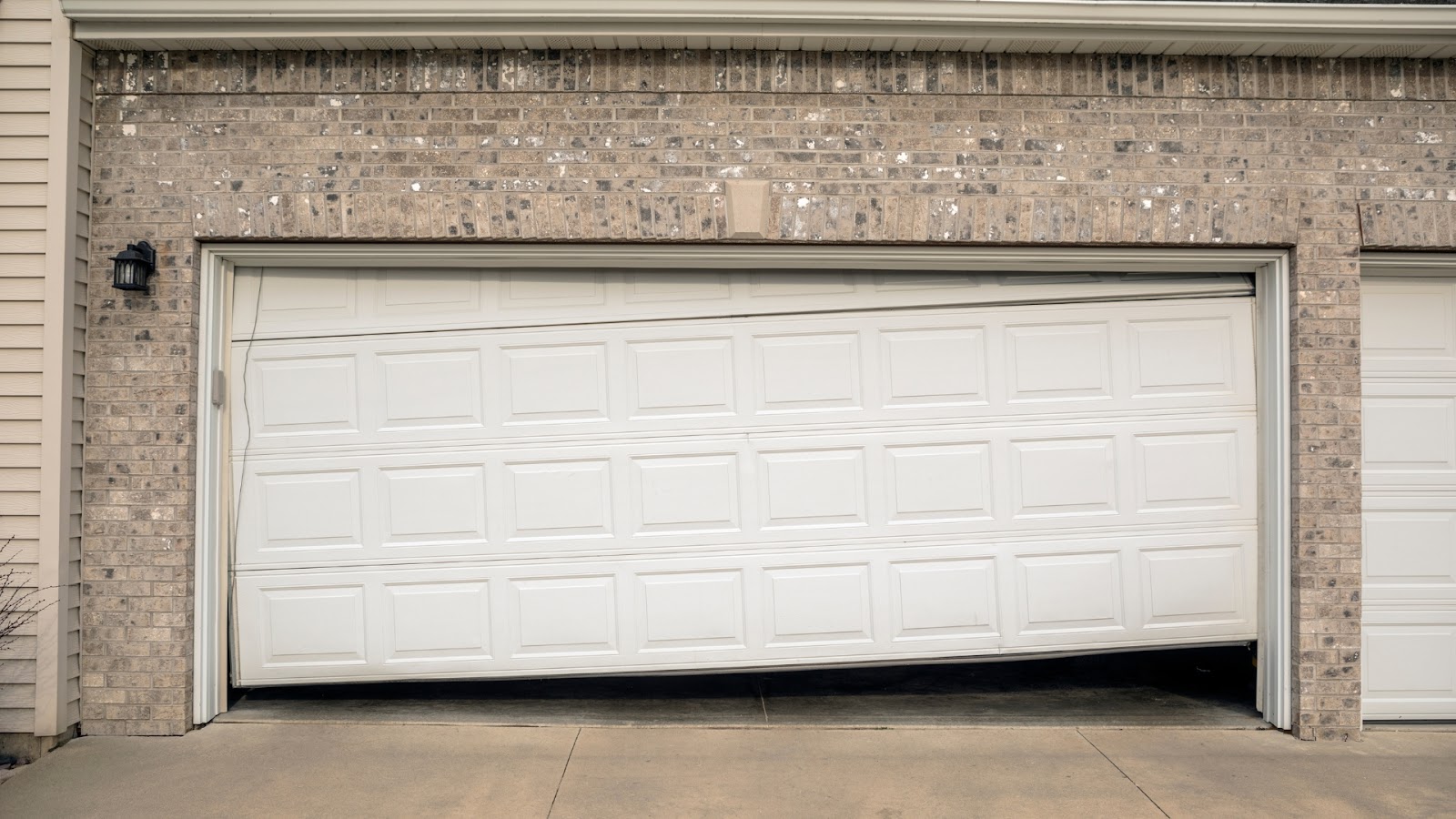 An uneven door that needs garage door track replacement