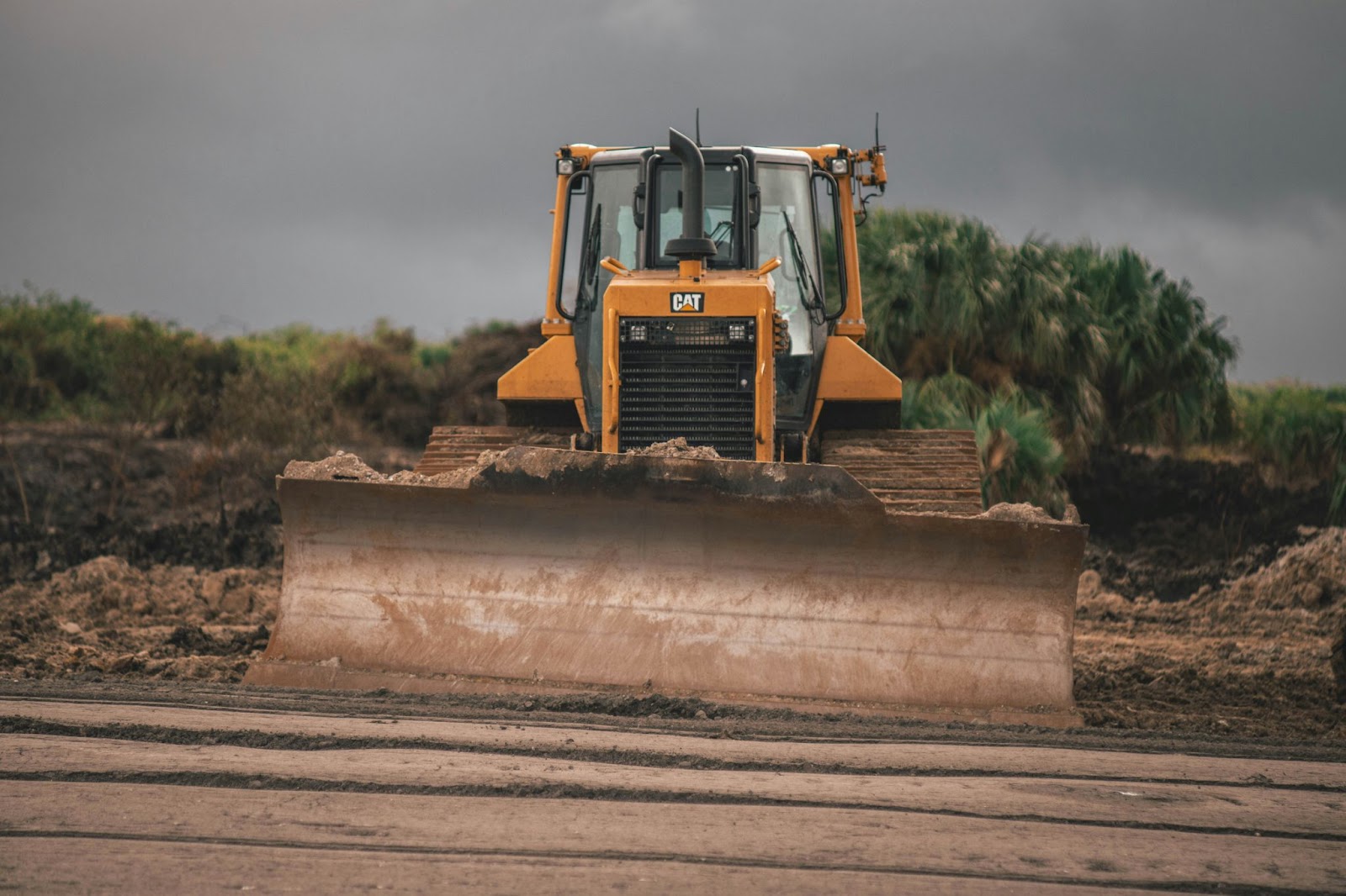 A bulldozer, a type of heavy construction equipment, moves earth on a site.