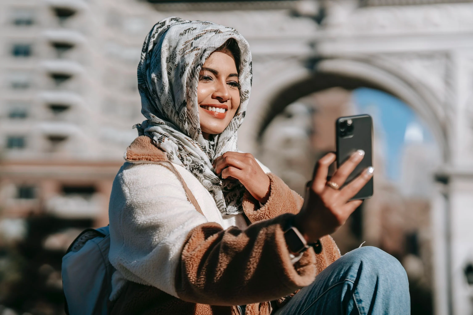 A ethnic woman taking a selfie at Washington Square Park