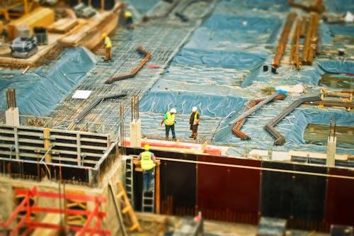 Free Man in Yellow Safety Vest Climbing on Ladder Stock Photo