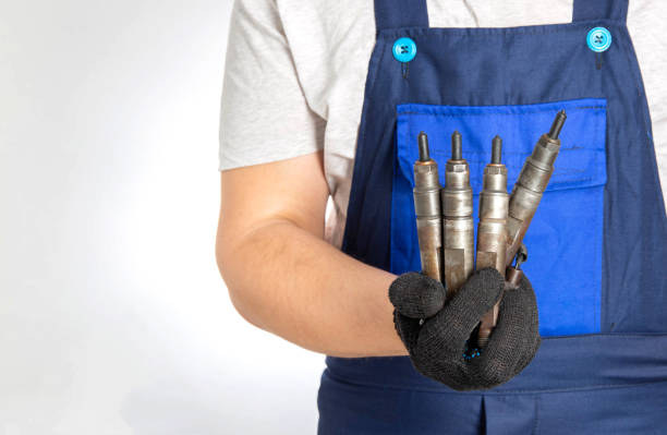A mechanic holding car parts