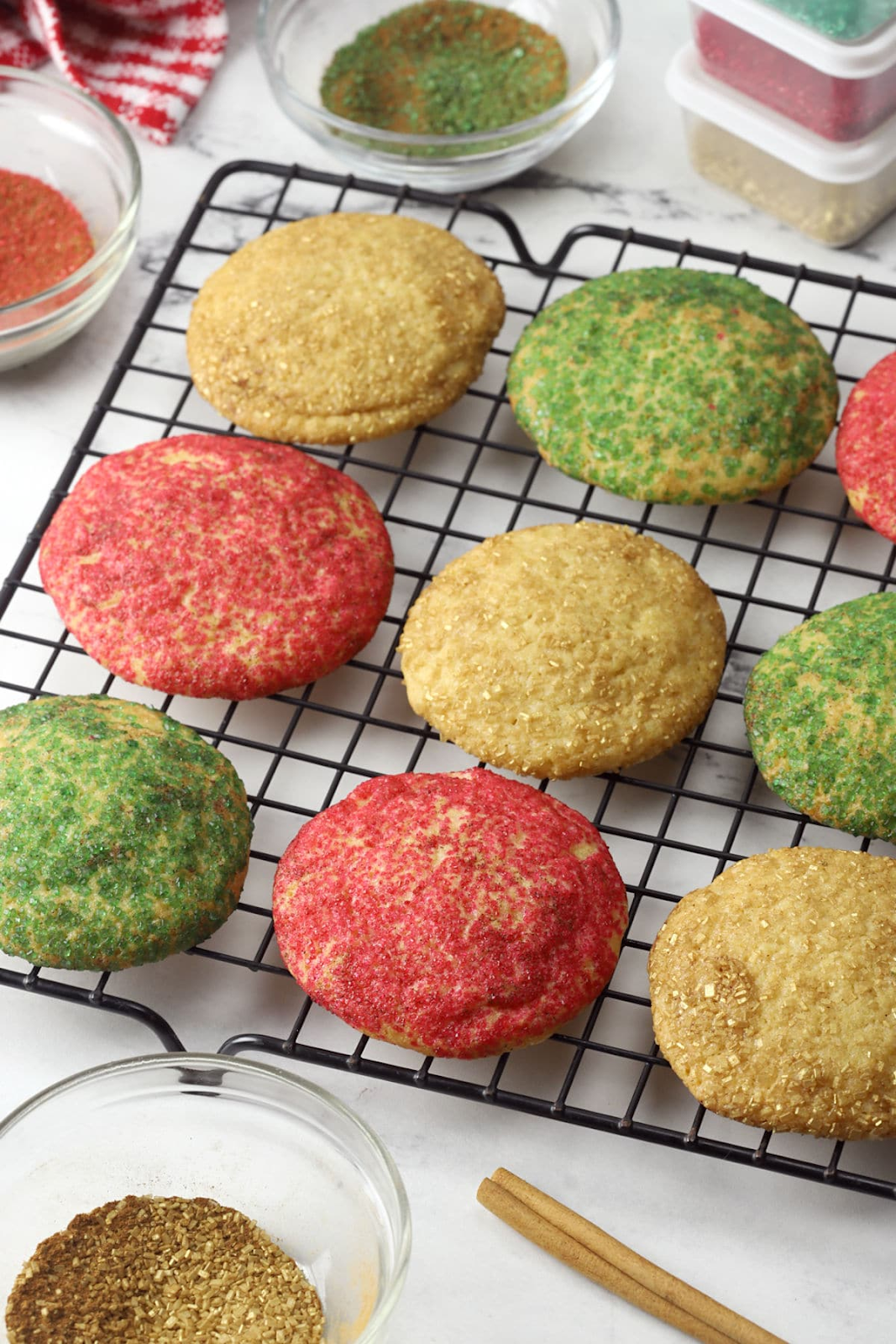 Snickerdoodle cookies are red, green and gold on wire rack