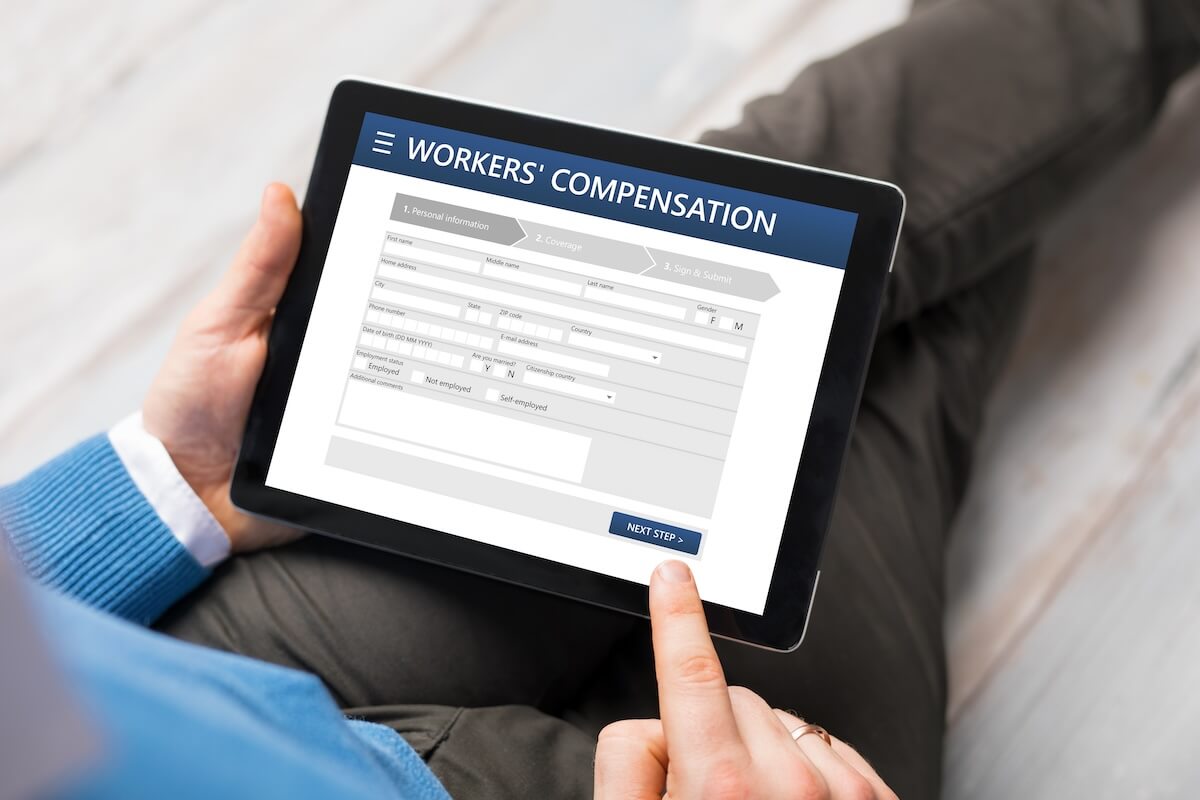 Workers comp claims process: person filling out a workers' compensation form online