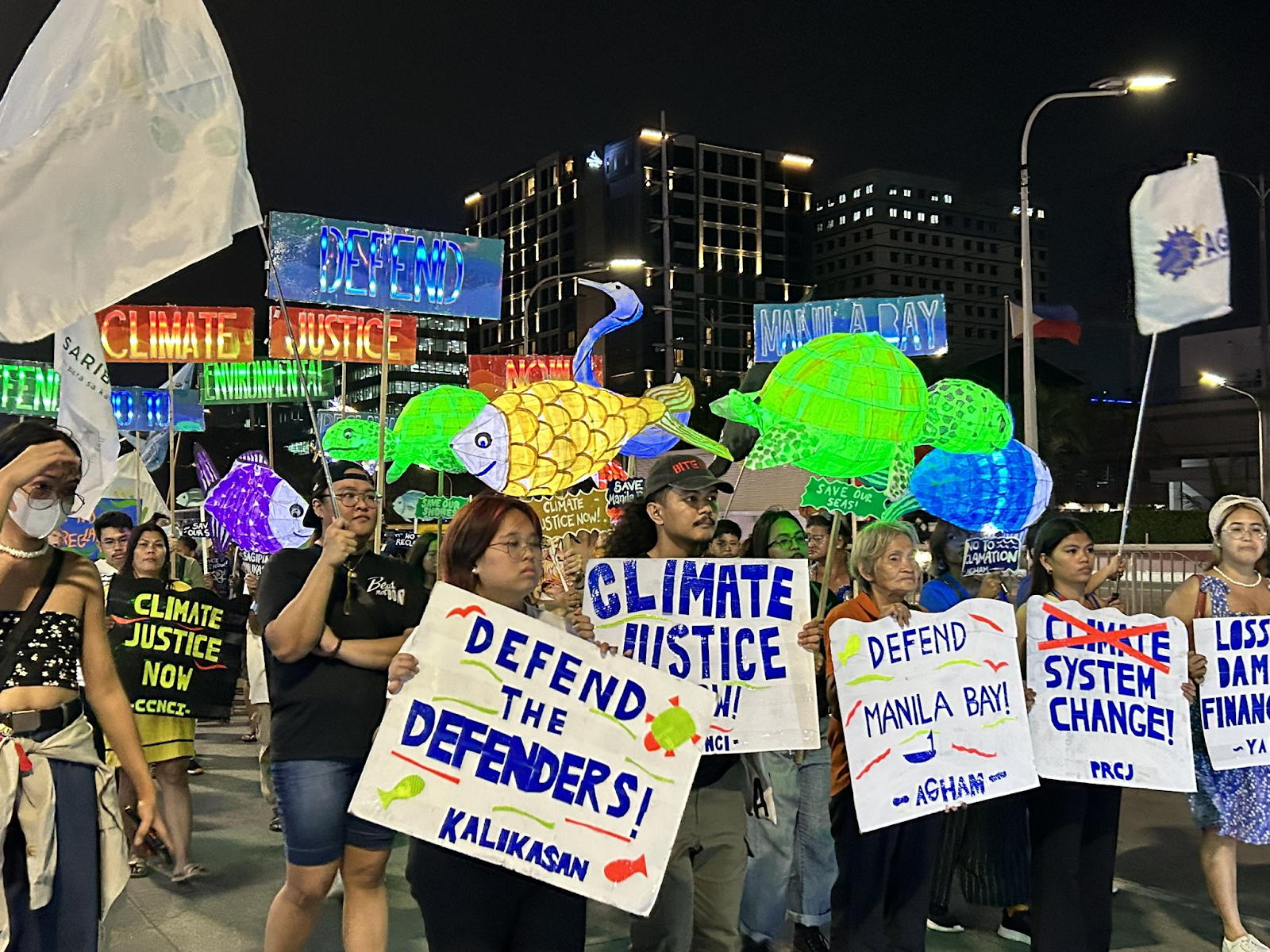   Picket signs and parols illuminate Roxas Boulevard as environmental groups hold a lantern parade on December 9 to protest reclamation projects in Manila Bay in time for the Global Day for Climate Action. 