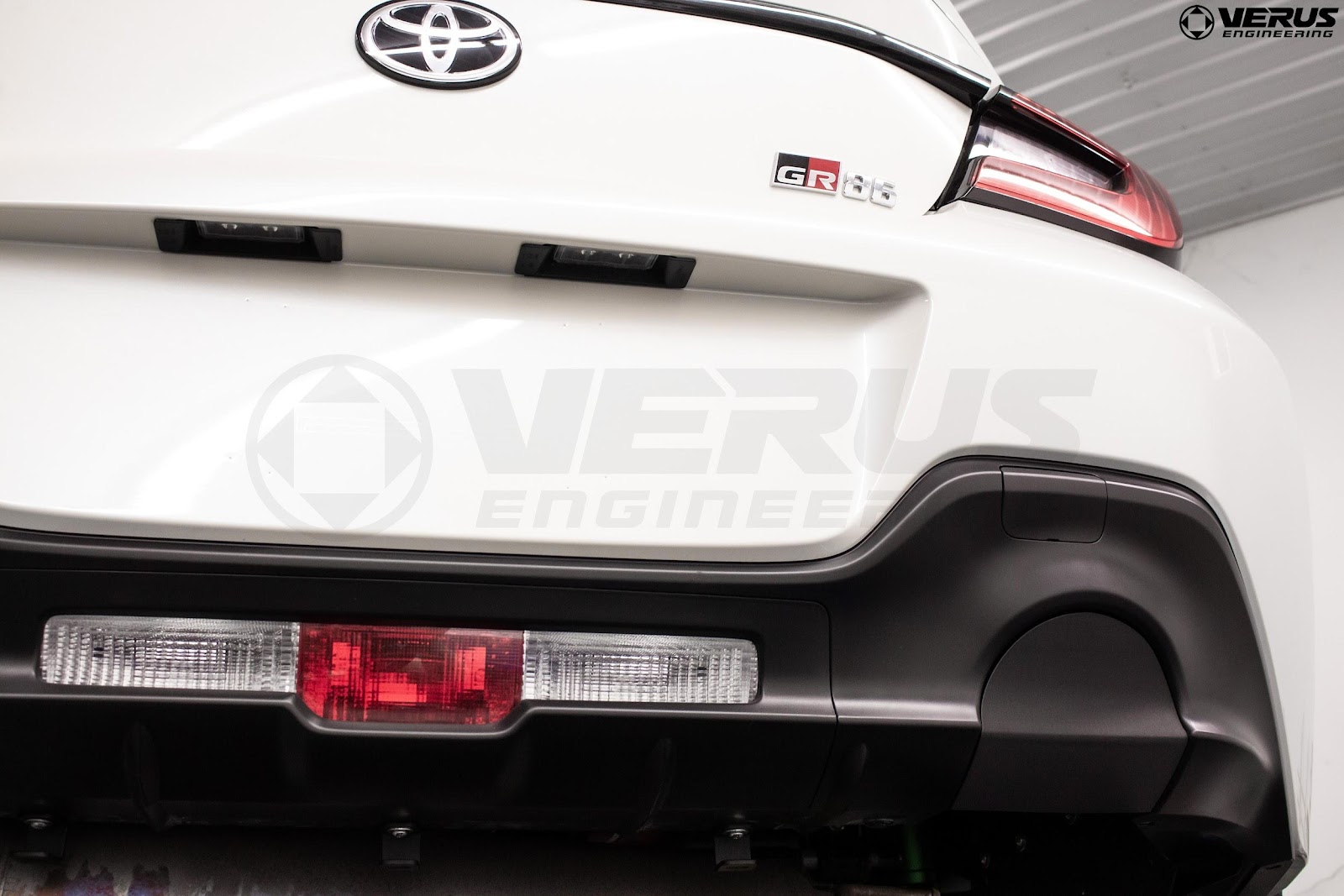 Exhaust opening of a Toyota GR86 is covered with a 3D-printed part made of carbon nylon material