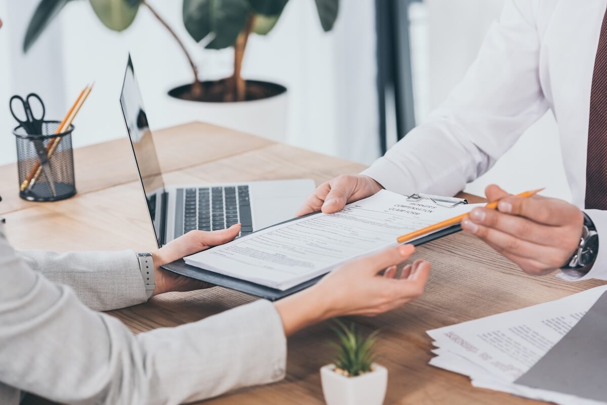 Insurance agent handing documents to his client