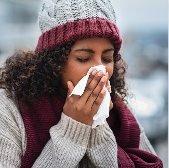 Woman with a cold sneezing