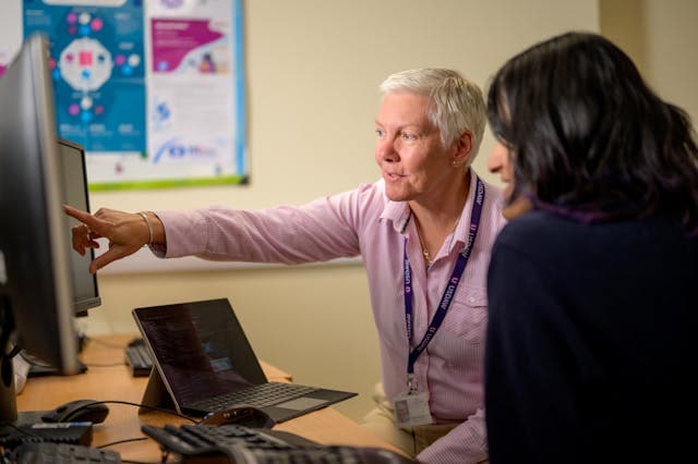 2 person looking at a computer screen