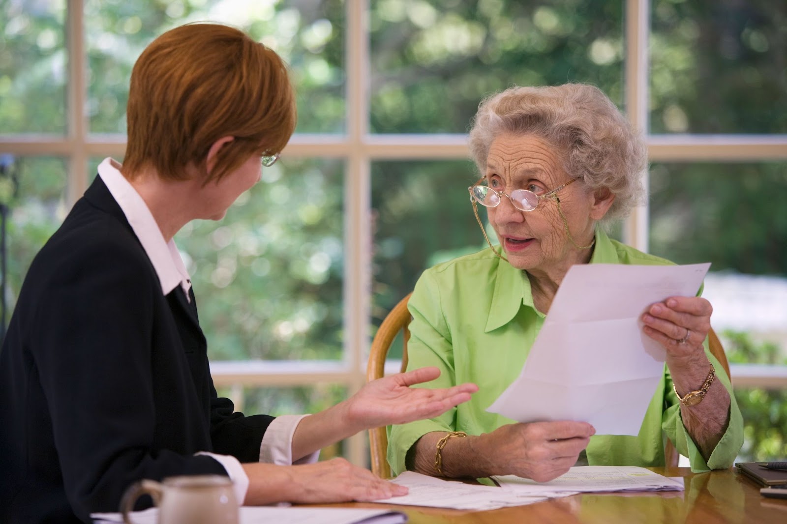 Senior consulting with financial advisor about assisted living costs