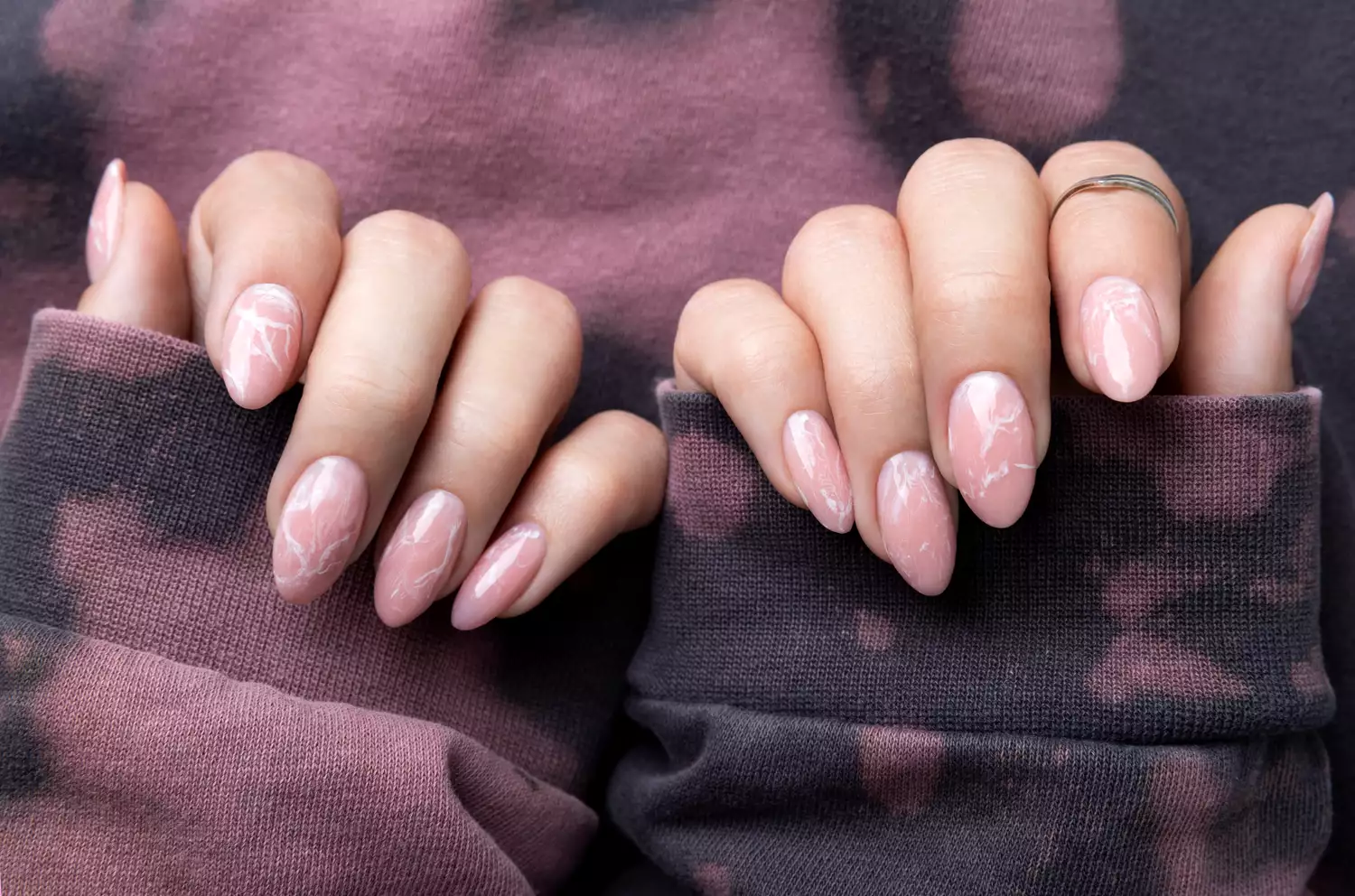 Picture showing a gorgeous pink marble  nail with swirls 