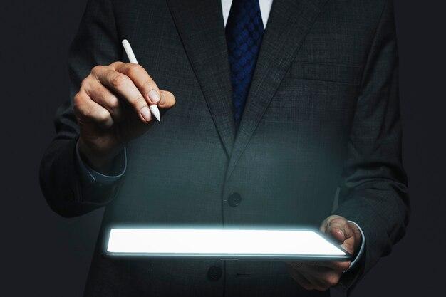 Businessman presenting invisible hologram projecting from tablet advanced technology