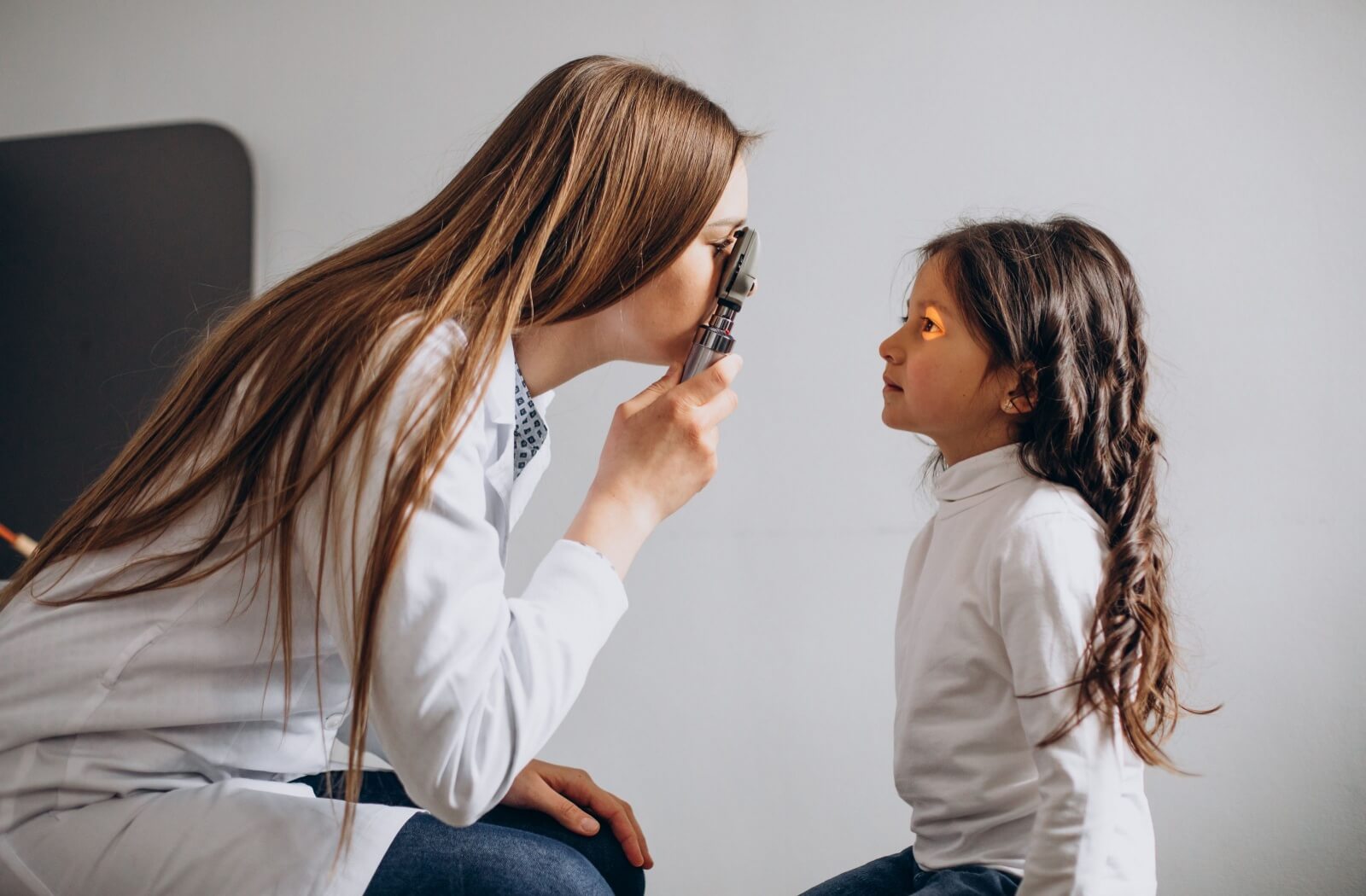 A child being examined by an eye doctor.