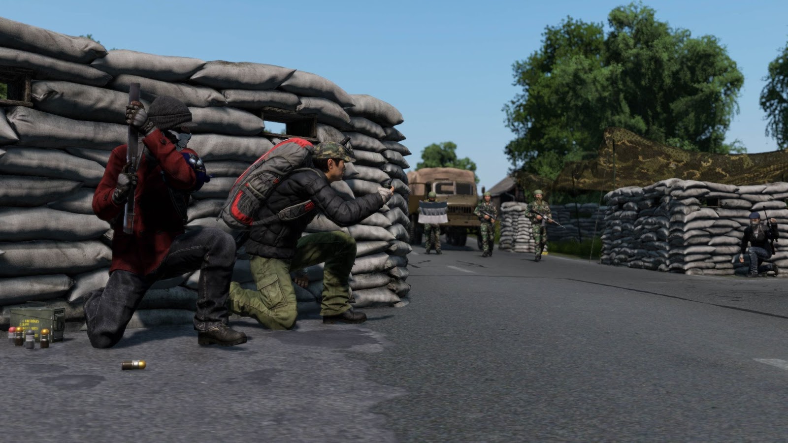 A screenshot of several players crouching behind sandbags in DayZ.