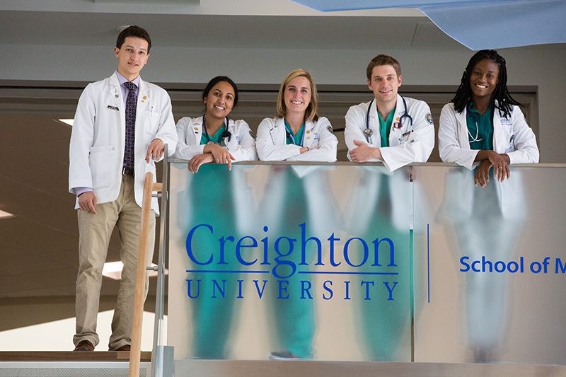 Five medical students posing upstairs