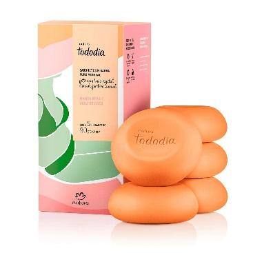 A stack of orange soaps next to a box

Description automatically generated