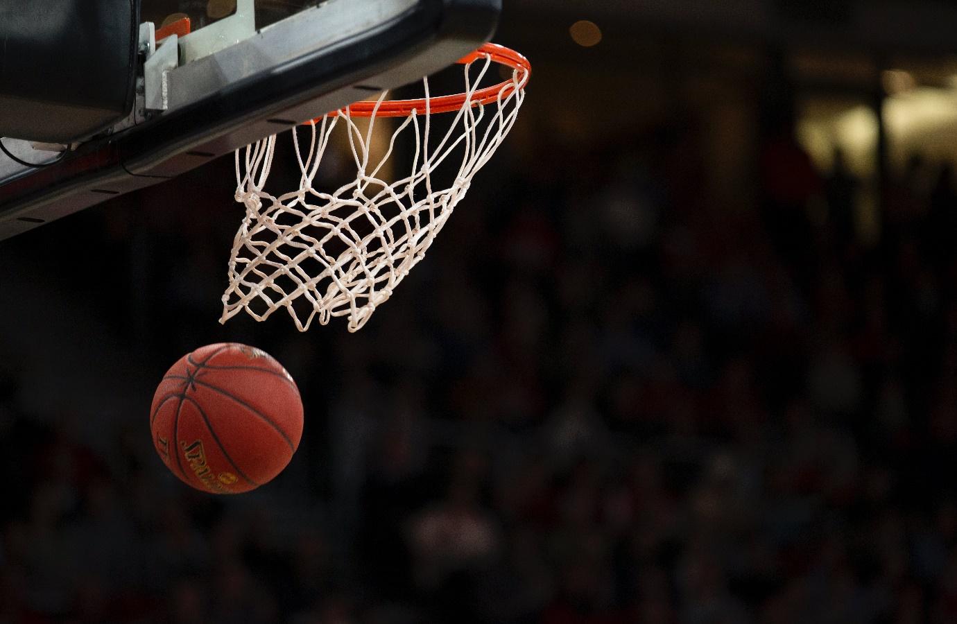 A basketball going into a net

Description automatically generated