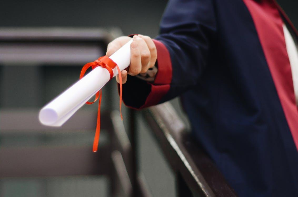 Free Person Holding White Scroll Stock Photo