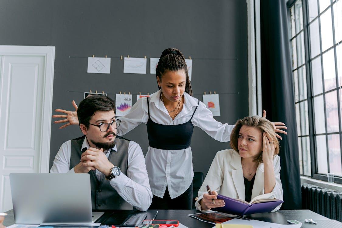 Free Employees in an Office and Gray Wall in Background Stock Photo