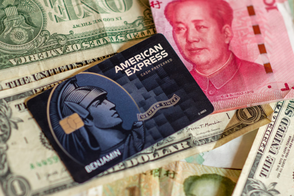 American Express Cash Magnet Card on top of dollar bills