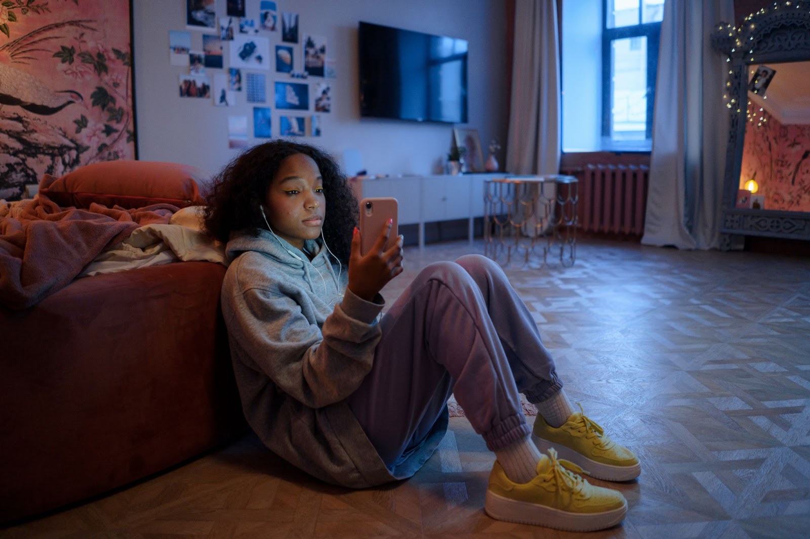 girl sitting in room with earphones in