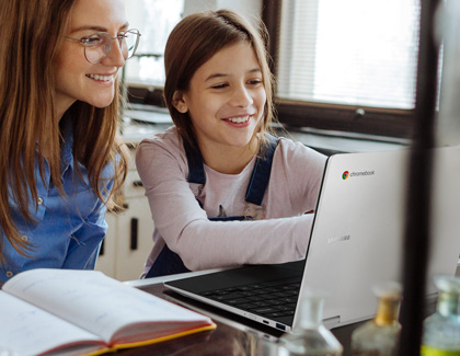 Mother and daughter smiling while using a Samsung Chromebook