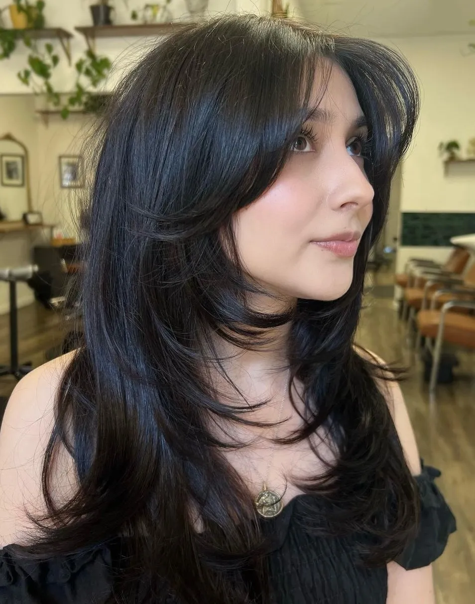 Picture of a lady wearing Medium Hair with Wispy Layers
