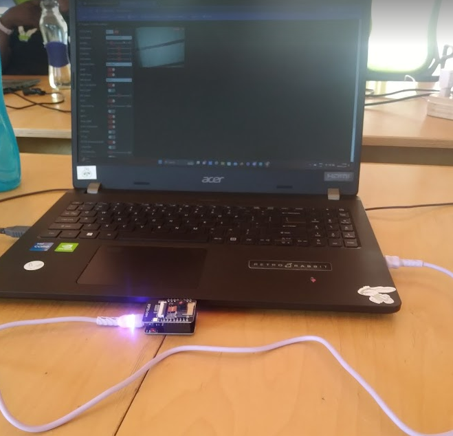Glowing IoT device connected to a laptop