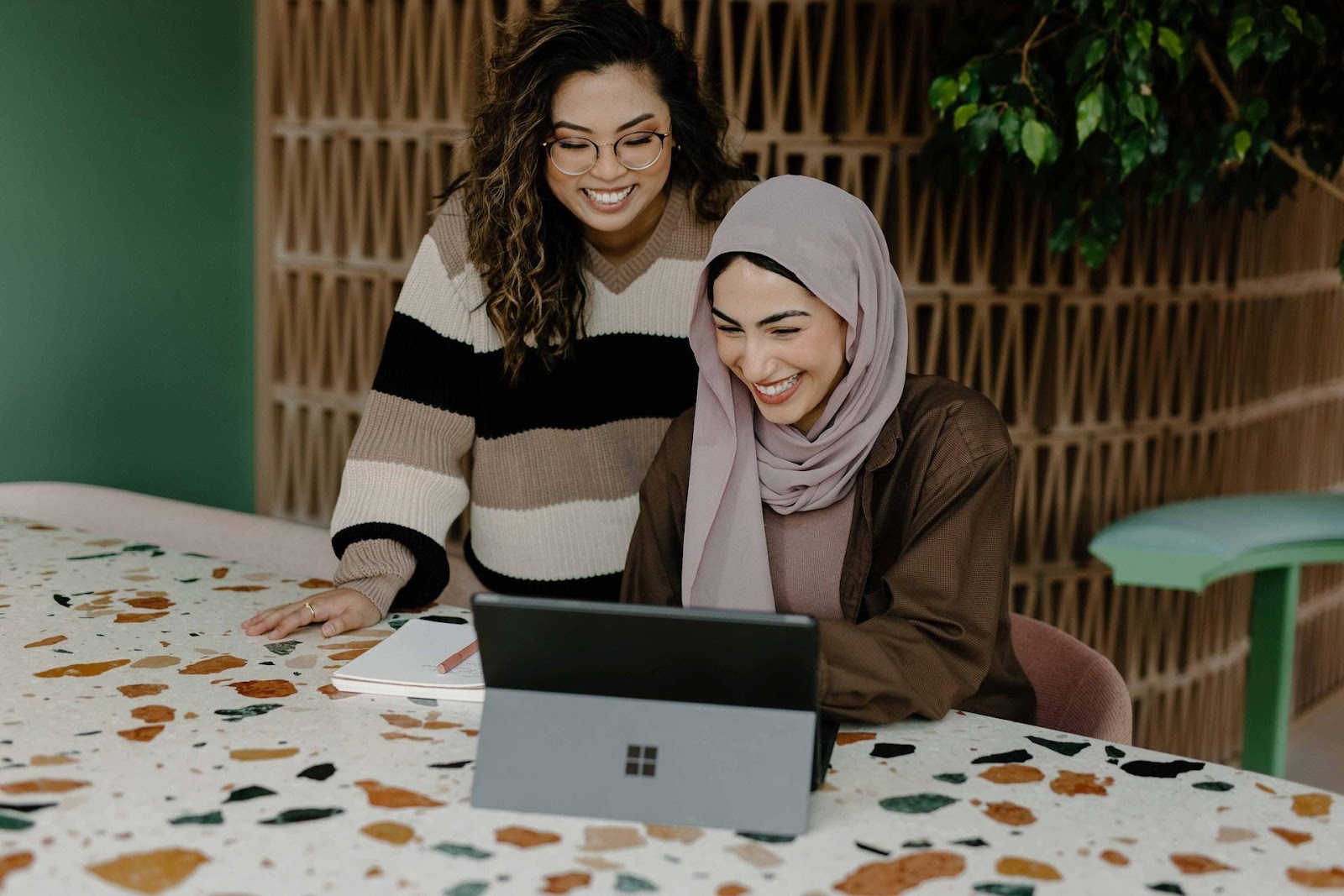 Two women smiling at a computer
