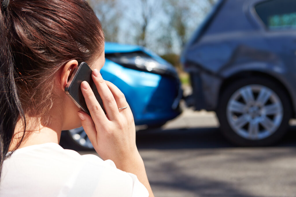 woman calling for help from an Indianapolis car accident lawyer after a rear end accident with multiple drivers involved