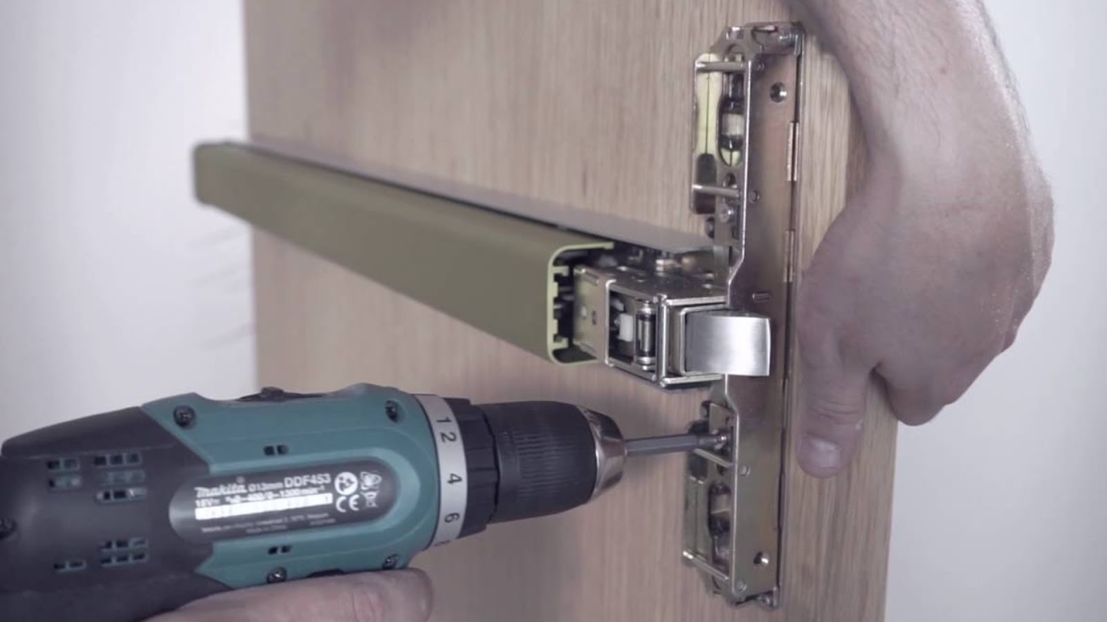 A locksmith installing a panic hardware