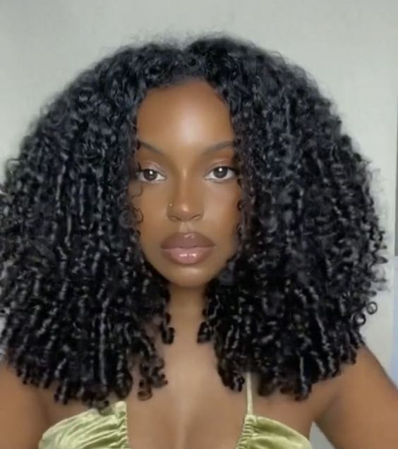 Lady poses for a selfie with her curly mane in view