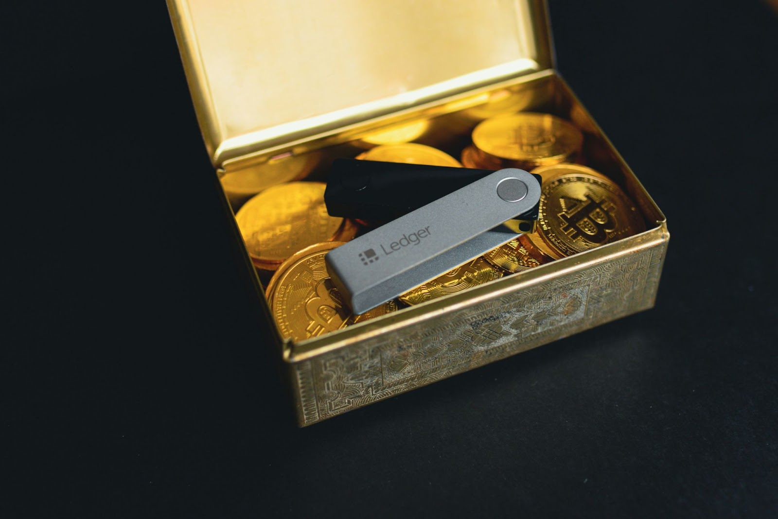 A metal box containing bitcoin coins
