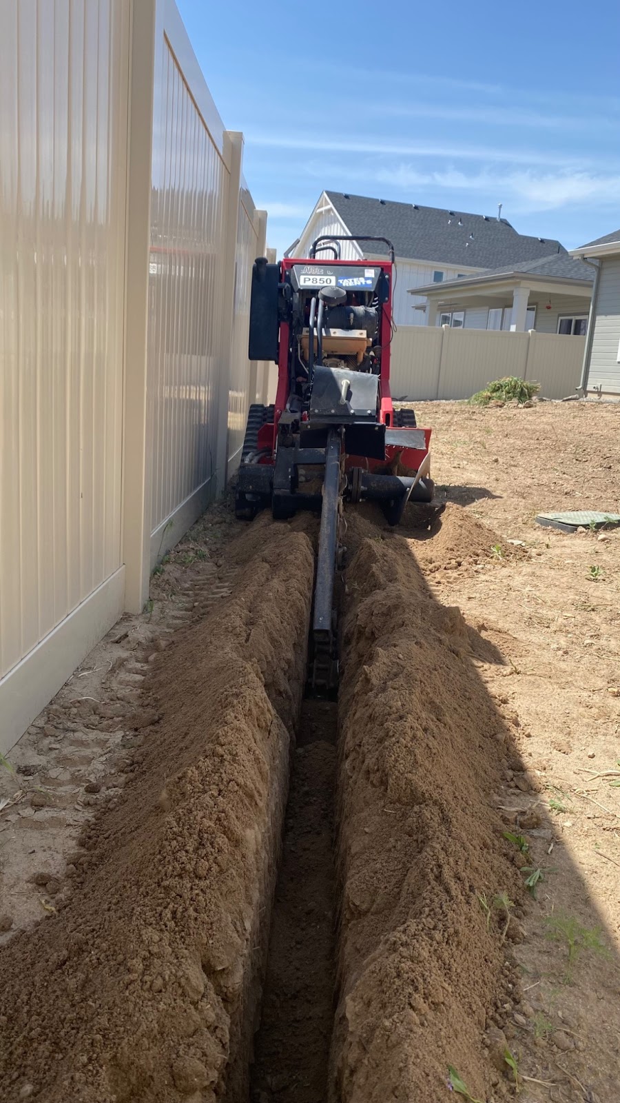 Barreto RTK Trencher cutting into the ground