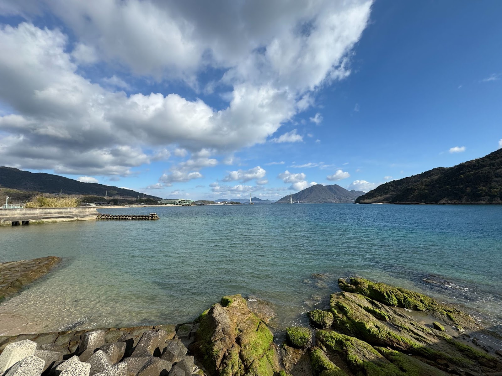 A stunning view along the Shimanami Kaido, complete with the sea, mountains, and a large suspension bridge