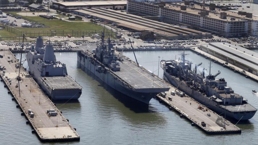 FILE - In this April 27, 2016, file photo, the amphibious assault ship USS Wasp (LHD-1), center, sits pier side along with support ships at Naval Station Norfolk in Norfolk, Va. The U.S. Navy amphibio