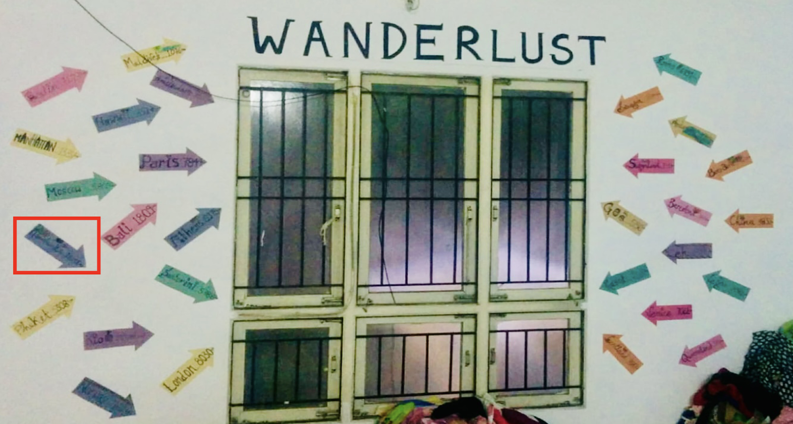 A wall of colorful arrows pointing towards the windows under the heading "Wanderlust." One blue arrow is highlighted.