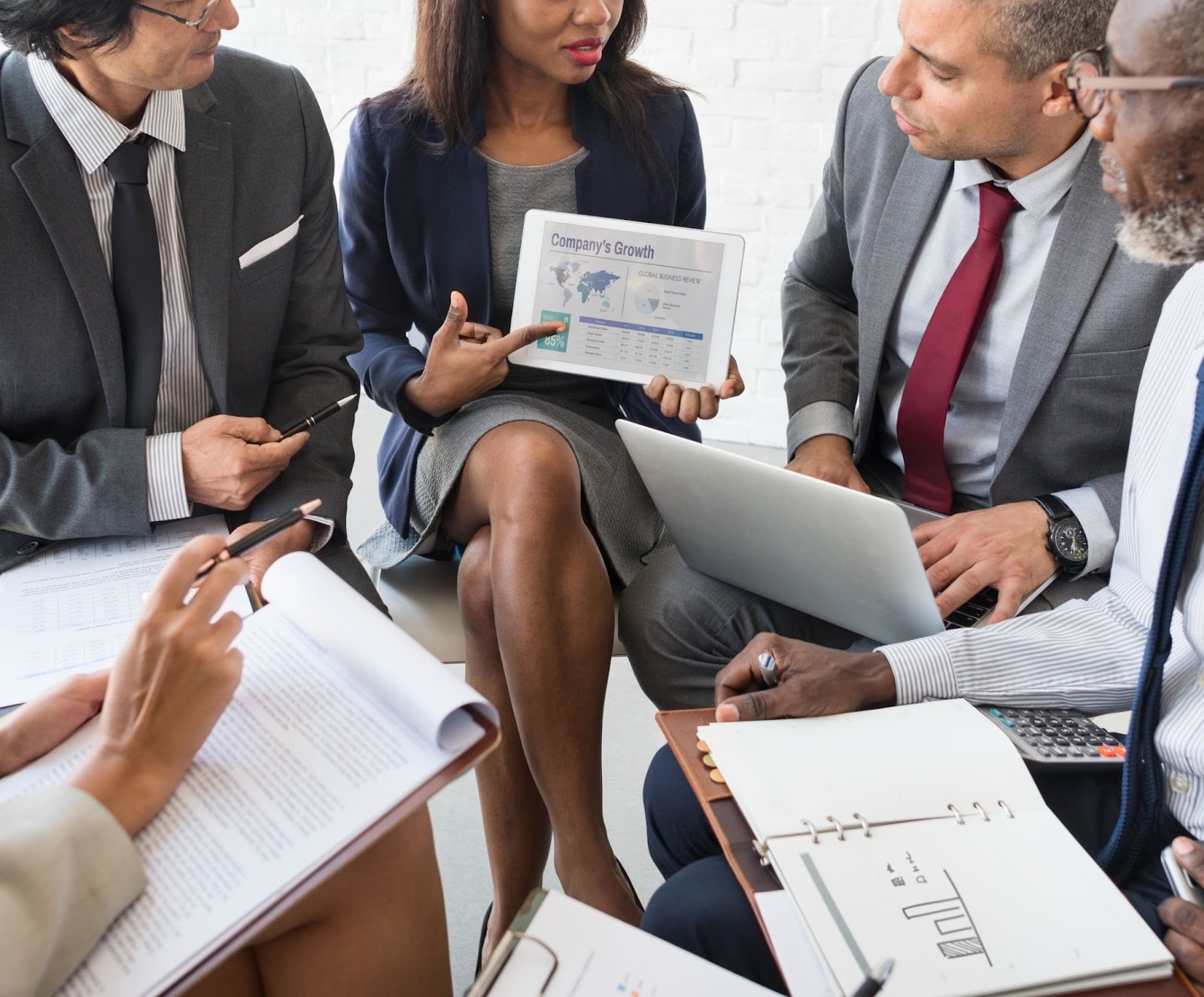 Four business professionals engaged in a strategic discussion about a marketing plan.