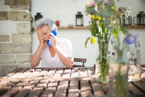 Free Elderly Woman Crying While on Phone Call Stock Photo